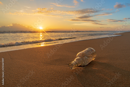 Glass bottle with beatiful beach sunset landscape
