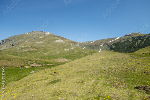 View of Bucegi Mountains, Bucegi National Park, Romania, clear blue sky, few clouds, sunny summer day, perfect for hiking