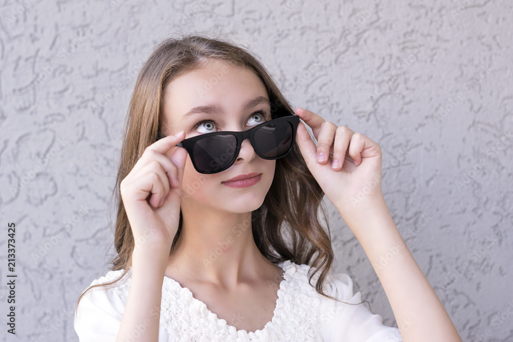 Cute girl posing in sunglasses Cute girl posing in sunglasses