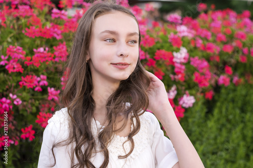 Charming young woman posing in park