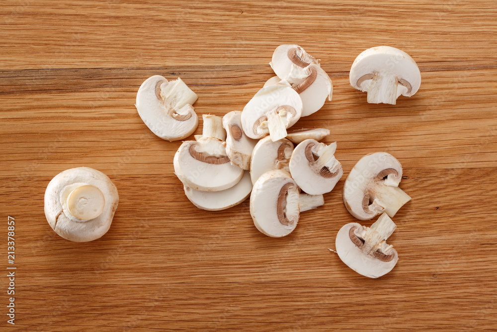 Cut mushrooms on a wooden Board. Top view. Cut mushrooms on a wooden Board. Top view.