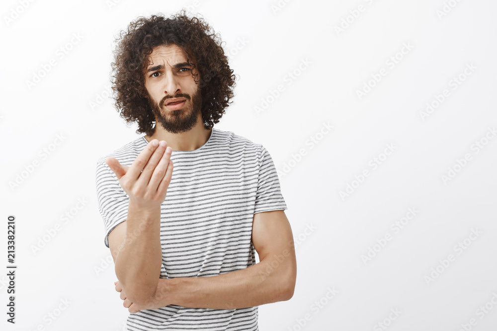 What is your point man. Displeased freaking out boyfriend with beard and afro haircut, shaking palm and pointing at camera, frowning while asking opinion or arguing with friend over gray wall What is your point man. Displeased freaking out boyfriend with beard and afro haircut, shaking palm and pointing at camera, frowning while asking opinion or arguing with friend over gray wall