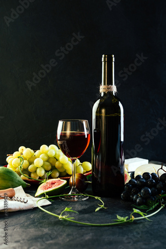 Red Wine Grapes Figs and Cheese on the Black Background