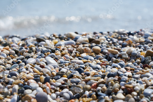 Pebble beach with blurred sea water on a background.  © Arthur