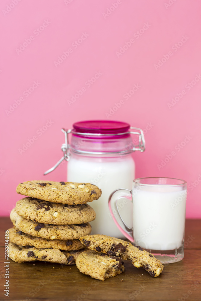homemade white and black chocolate cookies on wood table with milk homemade white and black chocolate cookies on wood table with milk