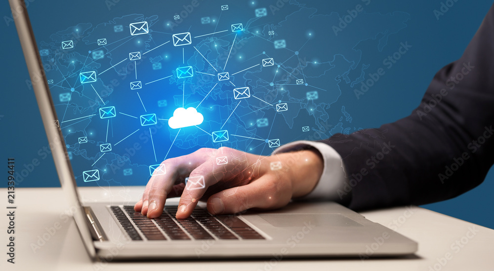 Businessman hand sending a bunch of messages on laptop with cloud computing concept
Businessman hand sending a bunch of messages on laptop with cloud computing concept