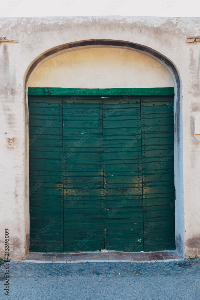 Green wooden old door in Rome, Italy