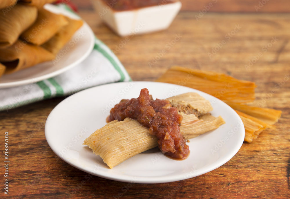 Homemade Tamale Unwrapped and On a Plate with Salsa Homemade Tamale Unwrapped and On a Plate with Salsa