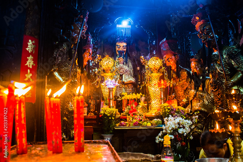 Statues and candles at mysterious Jade Emperor Pagoda, Ho Chi Minh City in Vietnam