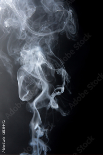 Texture of smoke clubs on a dark background.