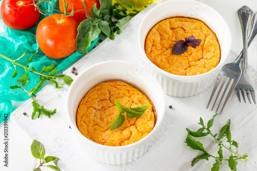 Vegetarian vitamin breakfast French baked cheese souffle with tomato on a wooden table. Vegan dish. Proper nutrition. Healthy lifestyle.