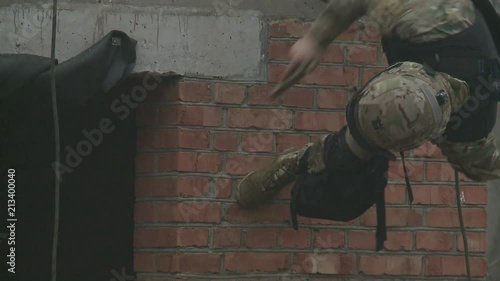 Subdivision anti-terrorist police during a black tactical exercises. Rope Techniques. Real situation.