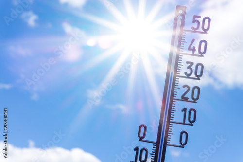 bright sun with thermometer. Summer background photo