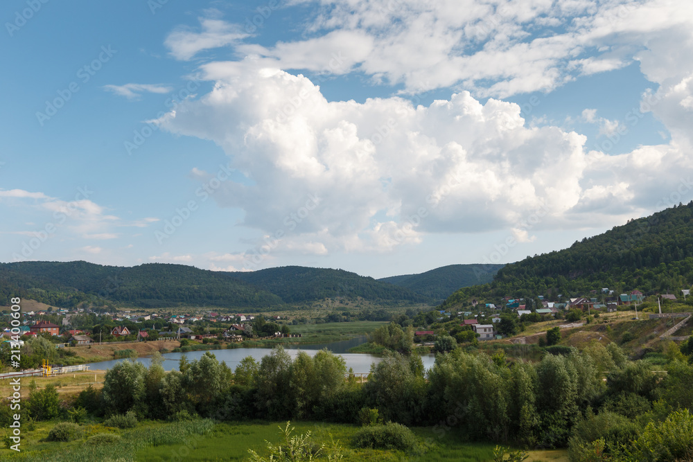 rural landscape on the mountains and a small river rural landscape on the mountains and a small river