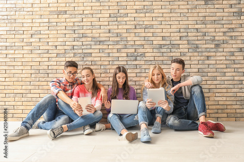 Teenagers with modern devic...