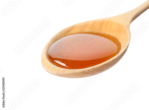 Spoon with delicious honey on white background