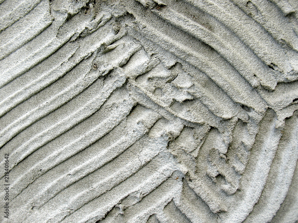 Gray plaster, putty, sand, wavy lines abstract texture background Gray plaster, putty, sand, wavy lines abstract texture background
