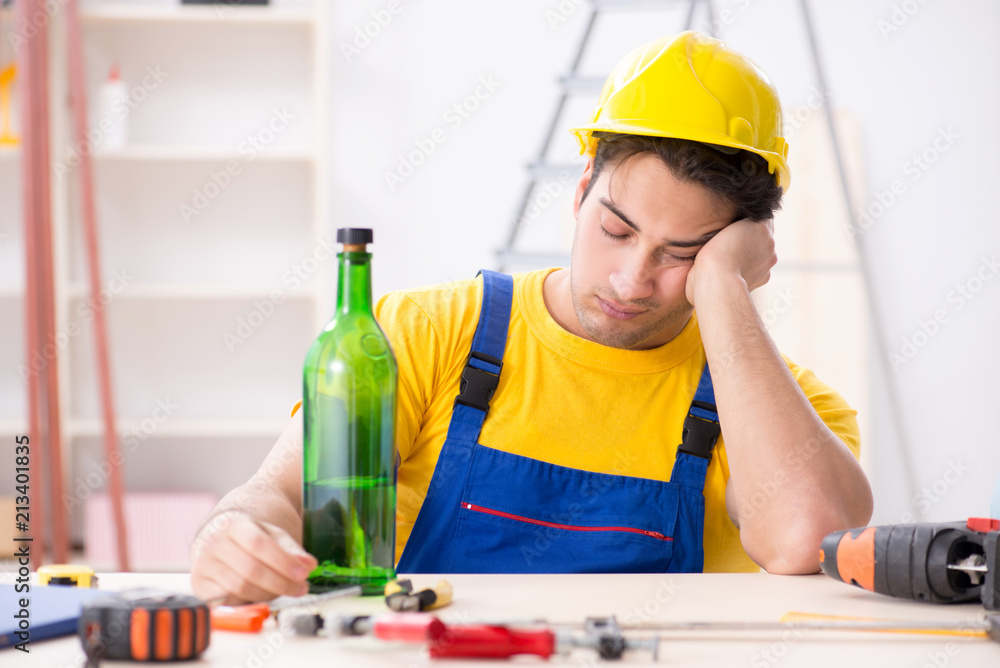 Drunk engineer working in the workshop Drunk engineer working in the workshop