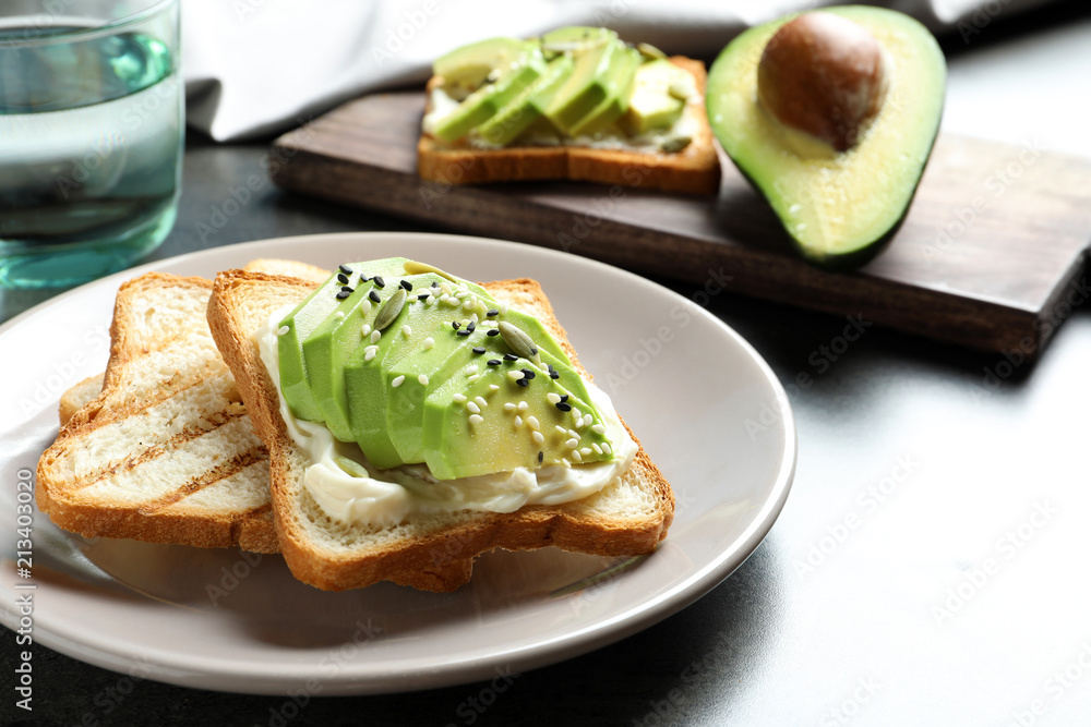 Toasted bread with avocado and seeds on table Toasted bread with avocado and seeds on table