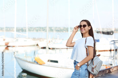 Young hipster woman in jean skirt on pier © New Africa