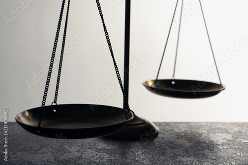 Scales of justice on table, closeup. Law concept