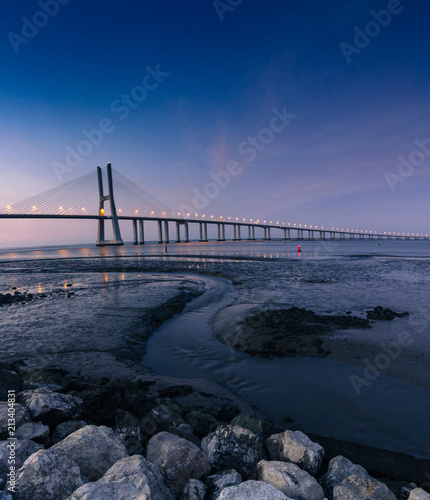 View of amazing Vasco da Gama Bridge at sunset. The Vasco da Gama Bridge crosses the Tagus River, and is one of the longest bridges in the world. Lisbon. Portugal.
