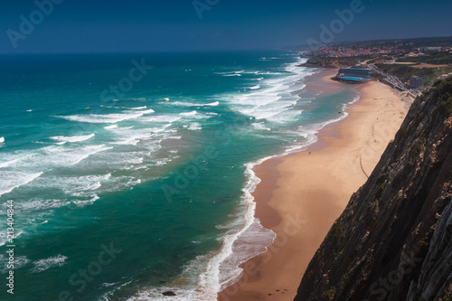 Amazing landscape of the beach of Praia Grande. View of Atlantic coastline - a long sandy beach and big waves. Sintra. Portuguese riviera. Portugal.