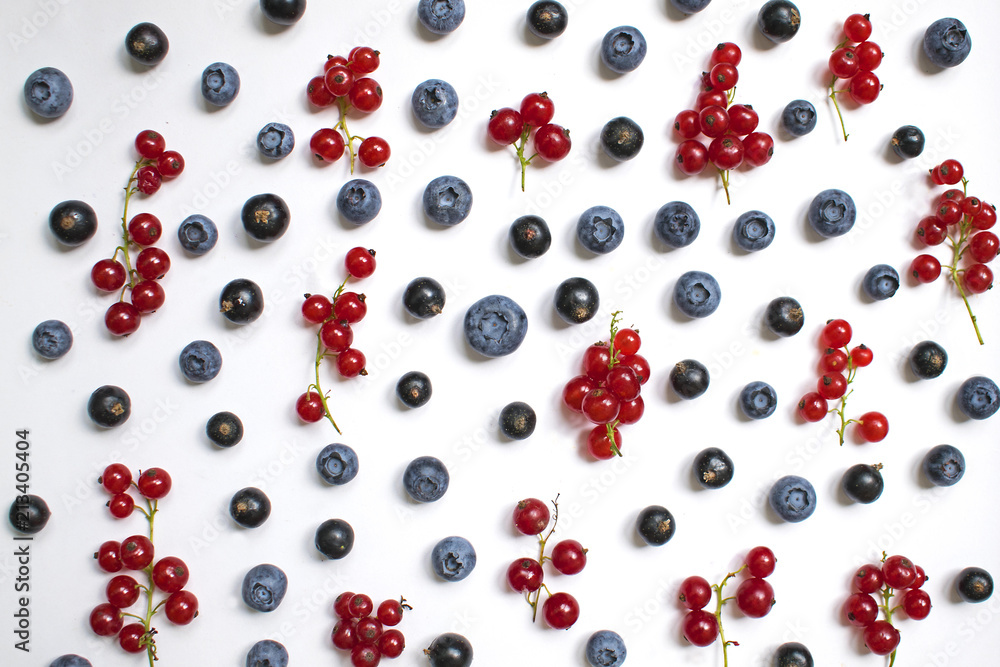 Red currant, blueberries and black currants on a white background. Creative flat layout of fruit, top view. Food wallpaper. Red currant, blueberries and black currants on a white background. Creative flat layout of fruit, top view. Food wallpaper.