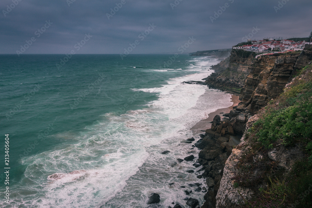 View of beach  with large waves near Atlantic coast. Large waves of turquoise water crushing on a beach Praia Grande, Sintra, Portugal. Travel concept. Vintage effect. 