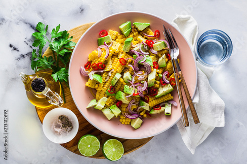 grilled corn , avocado salad with blue onion and chili pepper. healthy summer breakfast or lunch photo
