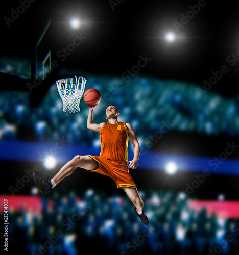 basketball player making slam dunk on basketball arena © 27mistral