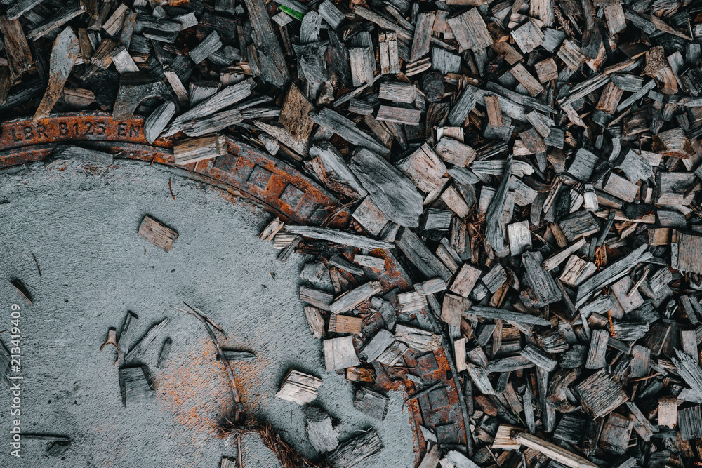 Small Wood Slivers Closeup with Manhole Cover Small Wood Slivers Closeup with Manhole Cover