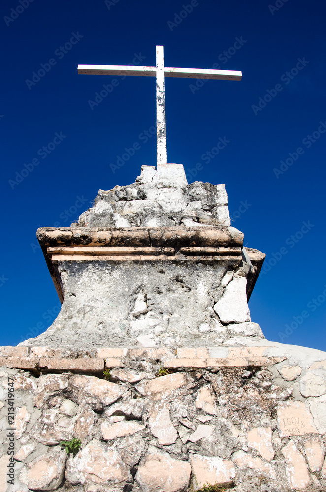 Stone and metal cross monument on top of a Puerto Vallarta hill Stone and metal cross monument on top of a Puerto Vallarta hill