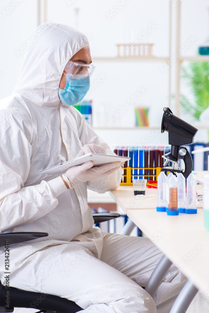 Young chemist student working in lab on chemicals Young chemist student working in lab on chemicals