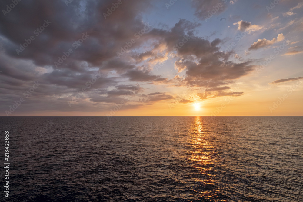 Water horizon with sun setting