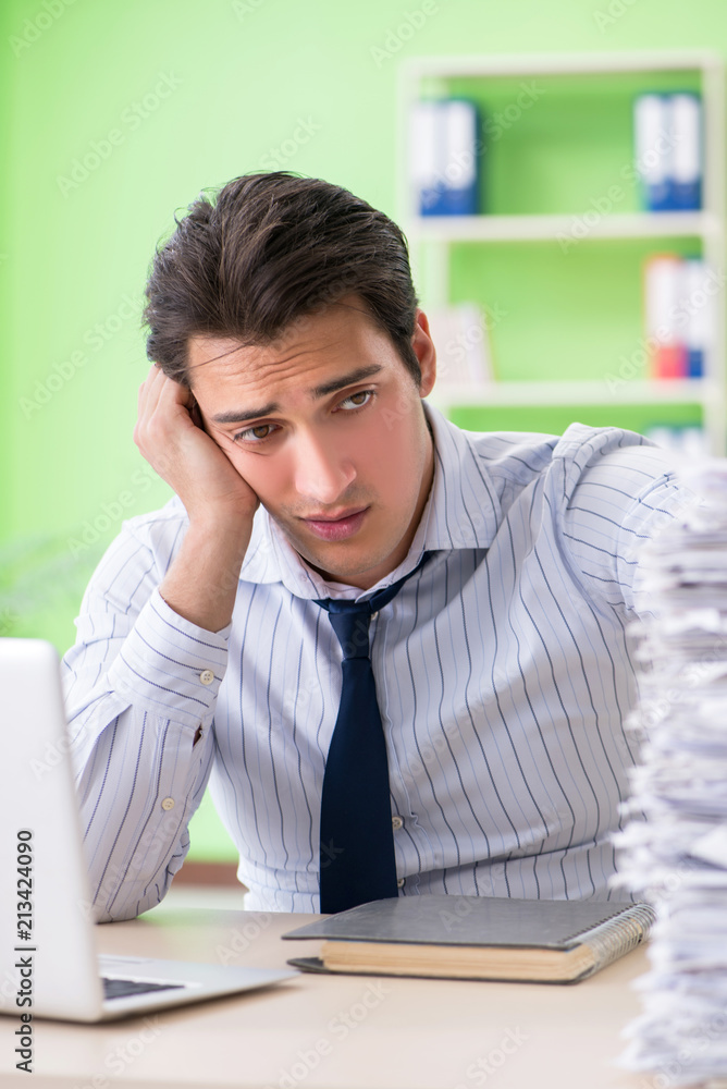 Businessman having problems with paperwork and workload