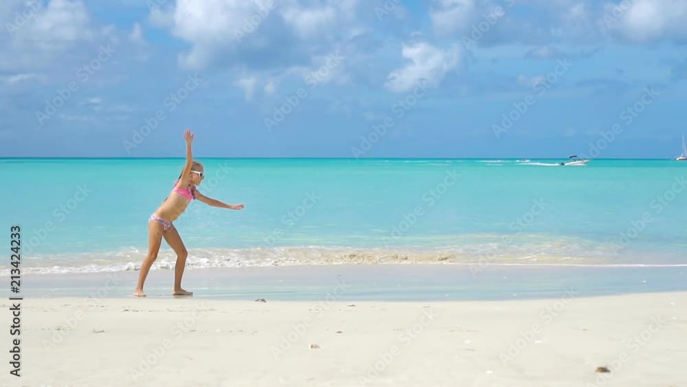 Adorable active little girl at beach during summer vacation Adorable active little girl at beach during summer vacation