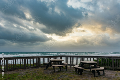 two picnic tables overlooking the ocean