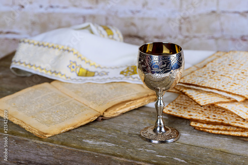 Jewish holidays: Passover Pesach matzah and a silver cup full of wine with a traditional blessing