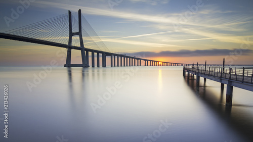 Vasco da Gama Bridge and pier over Tagus River in Lisbon, Portugal, at sunrise. © p_rocha