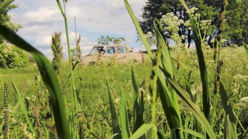 Grass flowing with the wind and a worker walking by photo