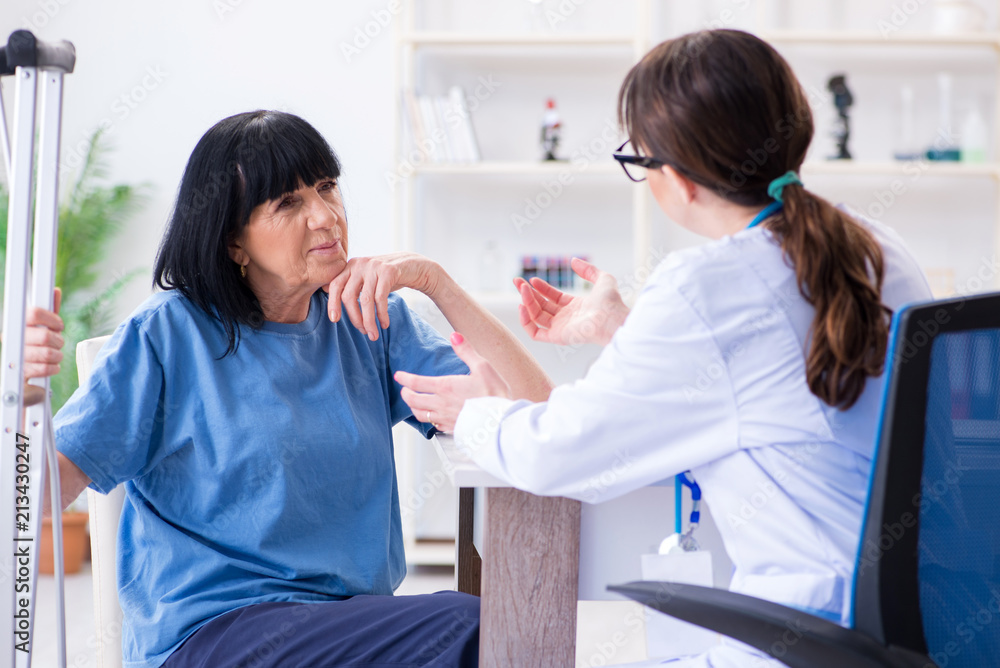 Doctor examining old mature woman after incident Doctor examining old mature woman after incident