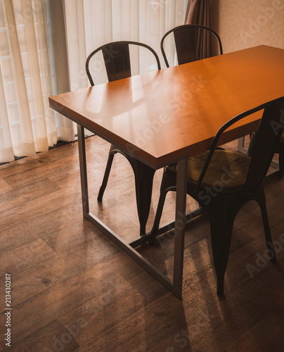 Dining table in the Cozy room on wooden floor.