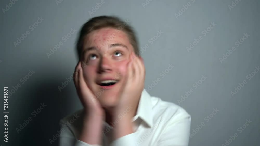 Emotional teenager boy in puberty period. Dermatological problems with skin Emotional teenager boy in puberty period. Dermatological problems with skin