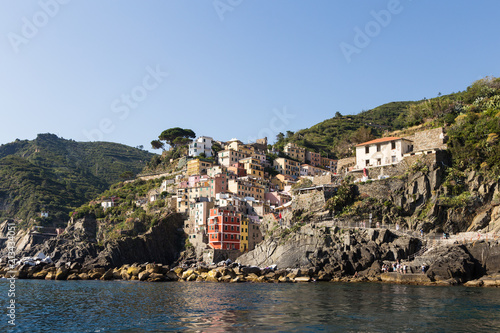 Stunning view from the sea of the Riomaggiore village in the Cinque Terre in Liguria, Italy