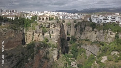 Aerial view of the historical Puente Nuevo Bridge, the newest and largest bridge that span the 120-metre-deep chasm that carries the Guadalevín River and divides the city of Ronda, in southern Spain.
