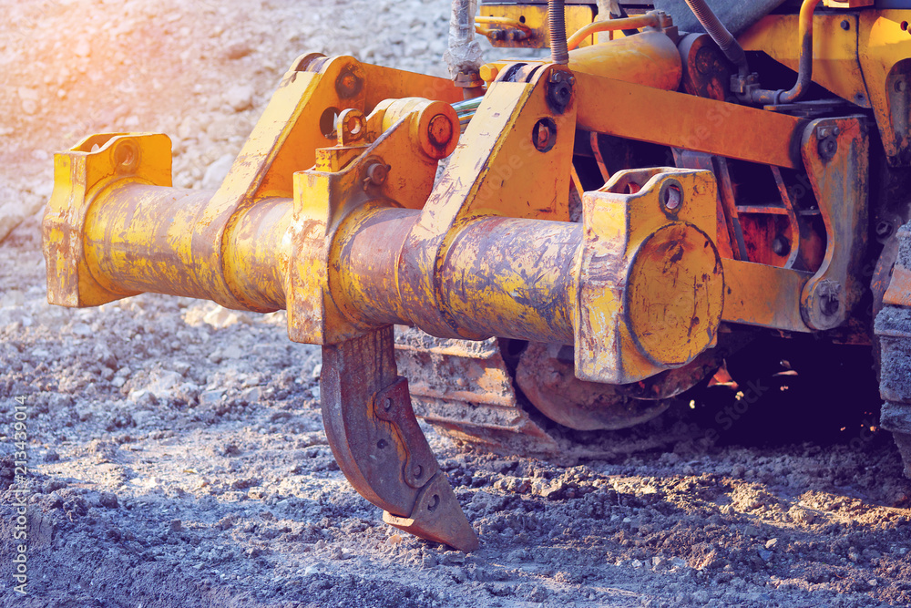 closeup of ripper or single shank on the back of the bulldozer, sunlight effect, toned closeup of ripper or single shank on the back of the bulldozer, sunlight effect, toned