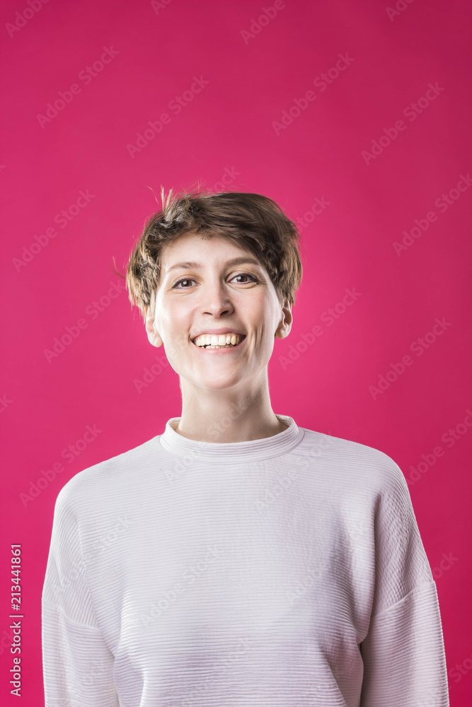 Front view of extremely happy and laughing young girl. Cute stylish model Front view of extremely happy and laughing young girl. Cute stylish model