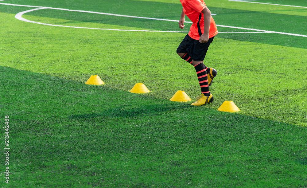 Soccer Football Training Session for Kid. Asian Boy Training Football on the Pitch. Soccer Football Training Session for Kid. Asian Boy Training Football on the Pitch.