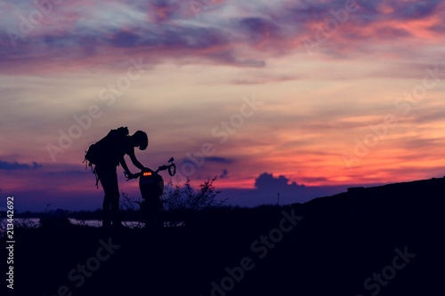 man and motorcycle in the sunset